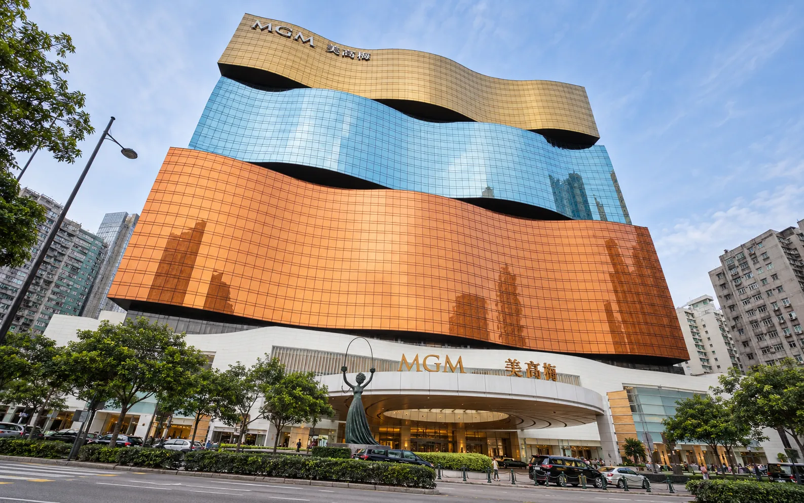 MGM Macau hotel tower with gold, blue and copper wave-shaped glass facades