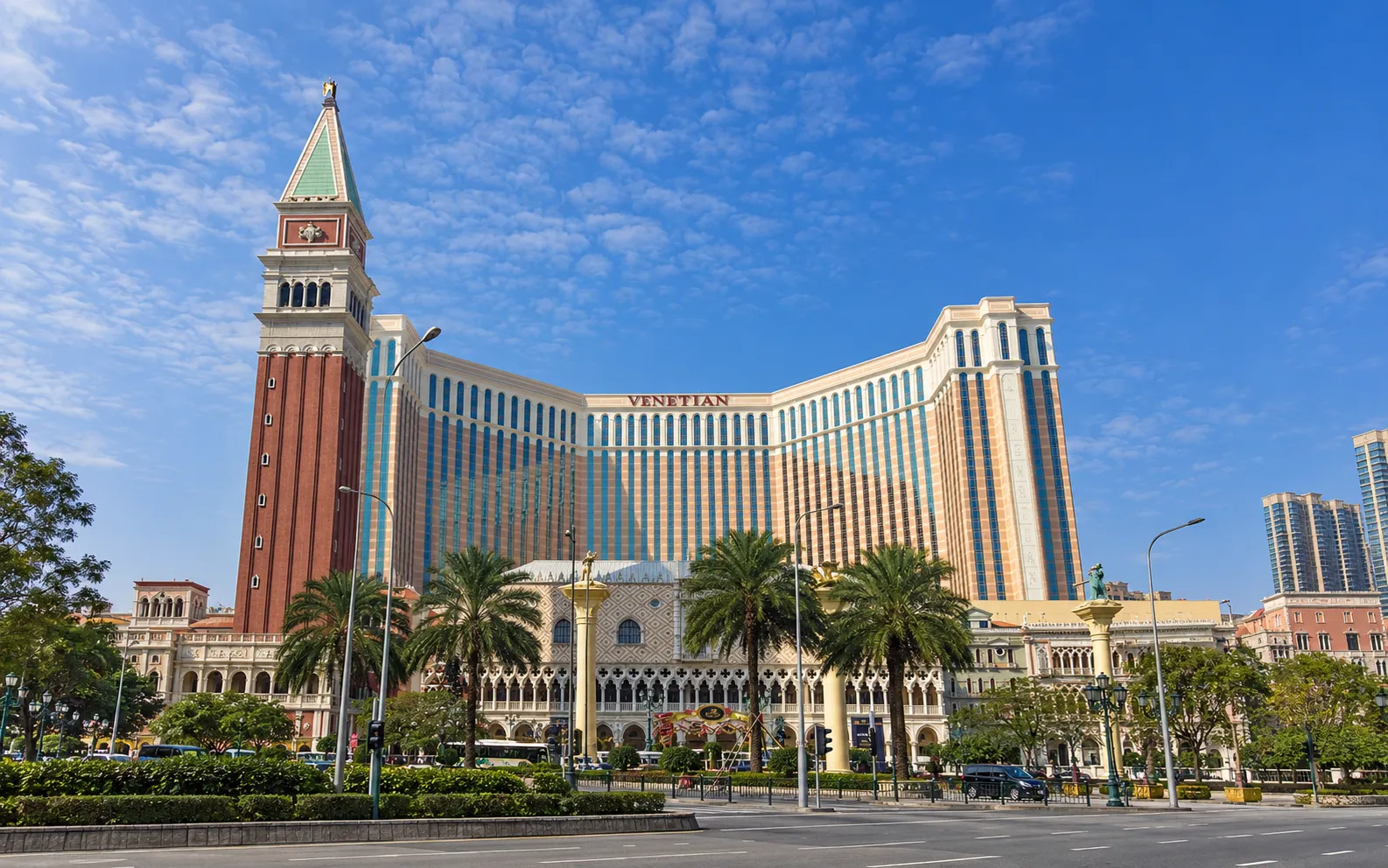 Resort building with a brick campanile tower and a VENETIAN sign on the hotel facade