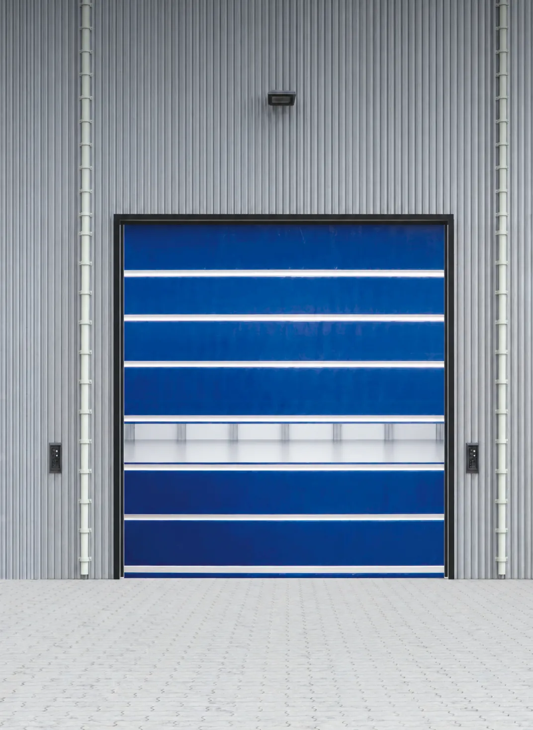 Blue PVC high speed door with a vision strip in a corrugated metal wall (rendering)