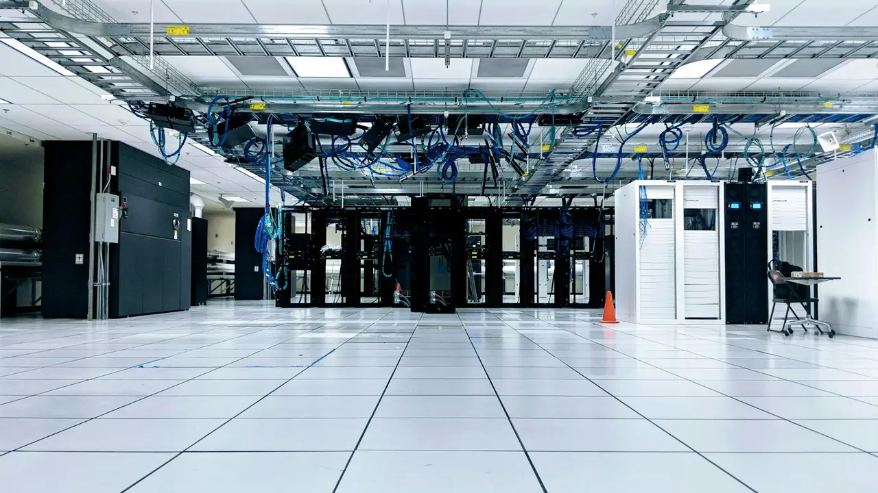 Data center hall with server racks and overhead cable trays