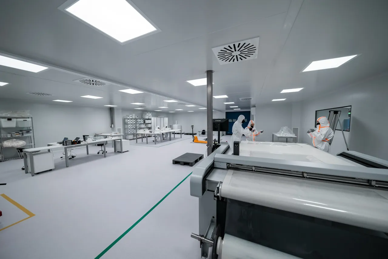 Cleanroom production area with staff in protective suits